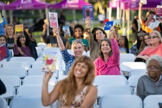 Writers holding books in the air