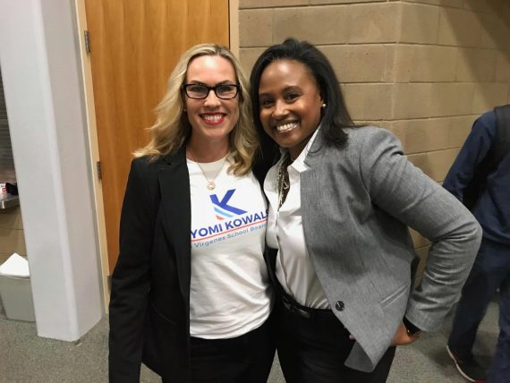 Two women in white shirts and business jackets